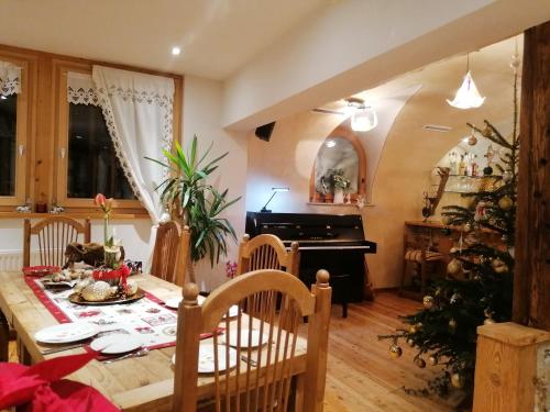 a dining room with a table and a christmas tree at Adler Hotel-Pension in Fulpmes