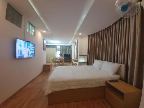 a bedroom with a bed and a flat screen tv at City Backpackers Hostel in Ho Chi Minh City