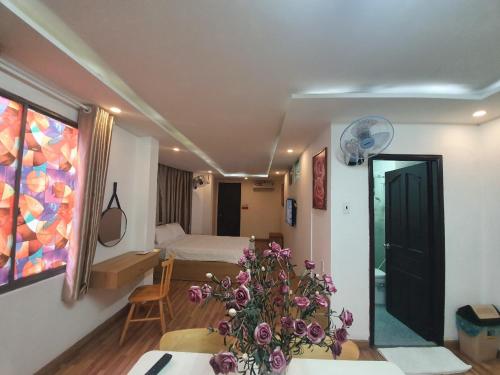 a room with a bed and a table with a plant at City Backpackers Hostel in Ho Chi Minh City