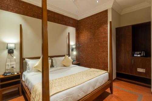 a bedroom with a large bed in a room at R R Heritage Resort Pure Vegetarian in Mahabaleshwar