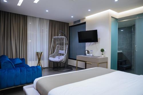 a hotel room with a bed and a tv at Brilliant Hotel & SPA in Golem