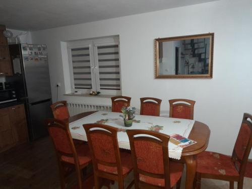 a dining room with a table and chairs and a mirror at Domek u Jaśka in Głębokie
