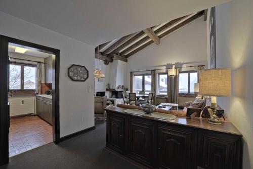 a room with a kitchen and a living room at Chesa Murtiroel - Samedan in Samedan