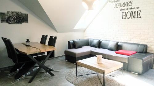 a living room with a couch and a table at Apartament LUX in Karpacz