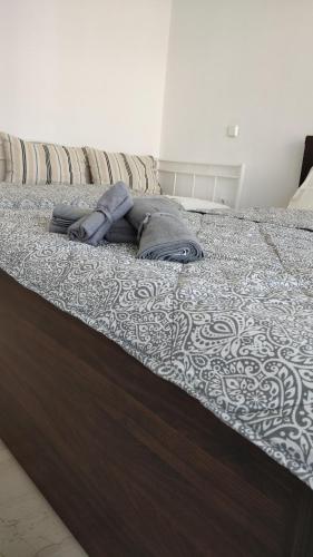 a bed with a blanket on top of it at Eclectic Apartment with Stunning Seaview in Porto Rafti