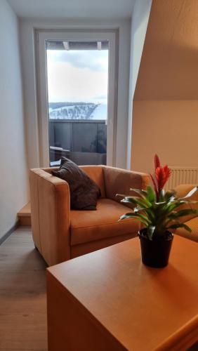 a living room with a couch and a table at Hotel Magdalenenhof inklusive MeineCardPlus in Willingen