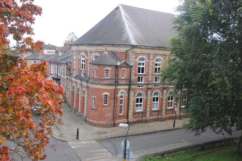a large red brick building with a black roof at Victorian Retreat in York