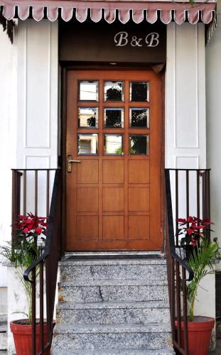 a wooden door on a house with stairs at Bhola Bhawan Bed and Breakfast in Jaipur