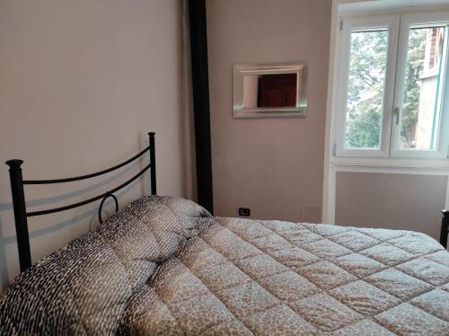 a bedroom with a bed and a window at Dentro il Borgo in Perugia