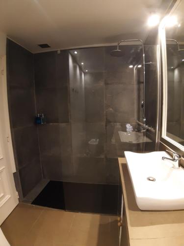 a bathroom with a shower with a sink and a mirror at BEACHFRONT Cascais,Estoril Apartment in Estoril