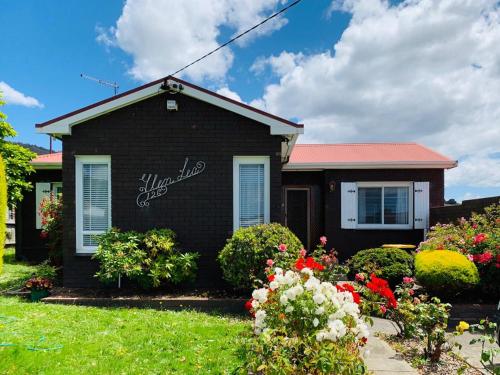 a house with flowers in front of it at Rose Homey Home in Glenorchy