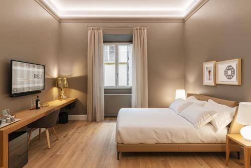 sypialnia z łóżkiem, biurkiem i oknem w obiekcie BSJ15-Borgo San Jacopo Room we Florencji
