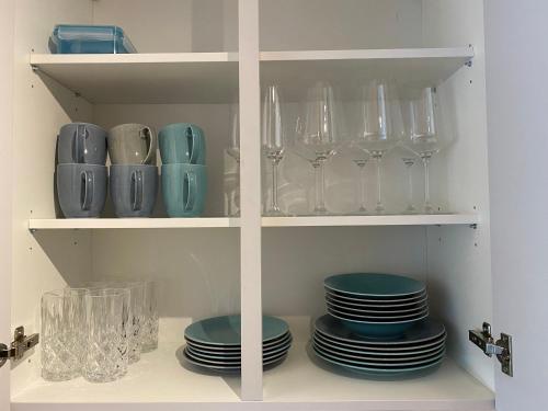 a cupboard with plates and glasses on it with at Hotel Schwarzer Adler in Pettneu am Arlberg