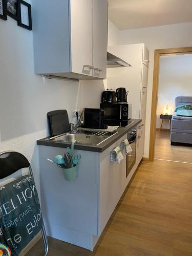 a kitchen with a sink and a stove top oven at Hotel Schwarzer Adler in Pettneu am Arlberg