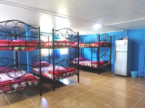 a room with four bunk beds with red pillows at Krasom Homestay in Phang-nga