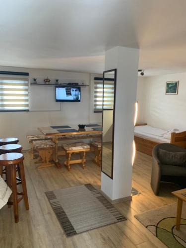 a living room with a couch and a table at NG Apartmani Tornik Zlatibor in Zlatibor