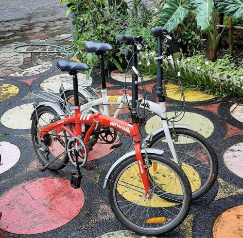 two bikes parked next to each other on a sidewalk at Villa Numismatik. Penginapan Unik yang Asri Alami in Cikundul