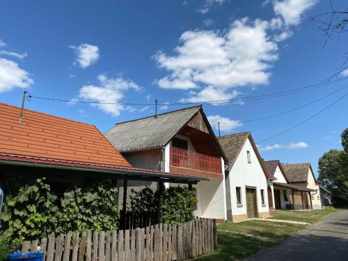 a row of houses with orange roofs at Het Romeo & Julia Huisje in Babarc