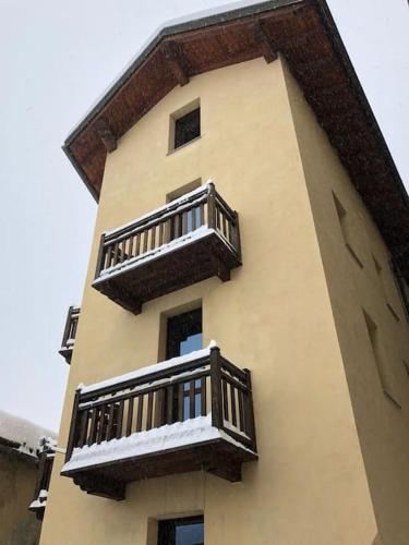 a tall building with balconies on the side of it at Chalet Motta in Valtournenche