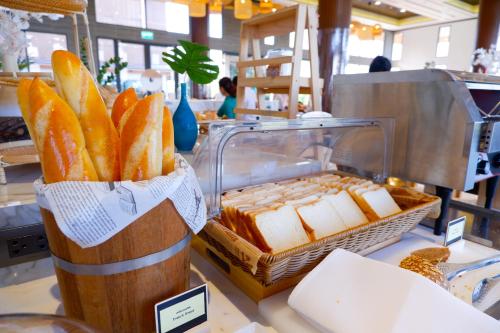 a bunch of bread in a basket on a counter at Laguna Grand Hotel & Spa Songkhla in Songkhla