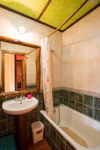 a bathroom with a sink and a bath tub at El Robledillo in Robledillo