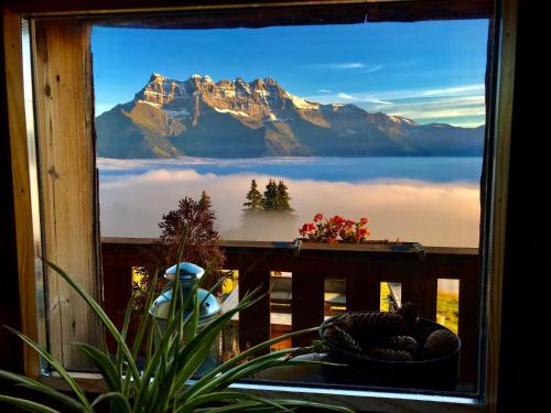a window with a view of a mountain at Chalet Chanso in Morgins
