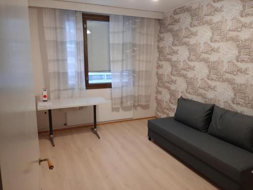 a living room with a couch and a desk at Апартаменты в Иматре in Imatra