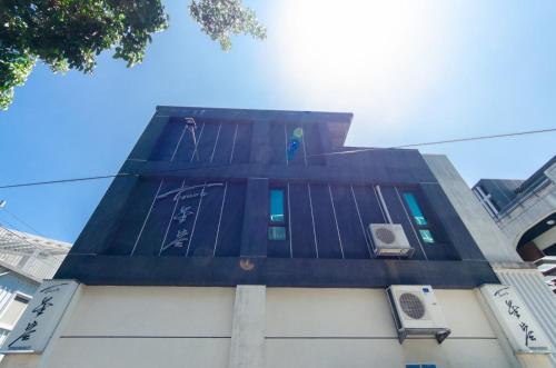 a tall building with a clock on the side of it at Touch 星空包棟民宿寵物友善民宿 in Wujie