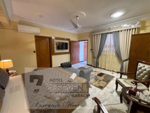 a living room with a bed and a couch at Hotel Seven 7 in Karachi