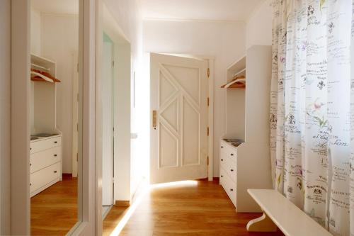 a hallway with white cabinets and a white door at ECO-LUX APART with free bicycles end free parking in Ljubljana