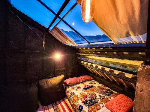 a bedroom with a bed in a room with a window at Wolf Totem Steam Punk Guesthouse in Pisac
