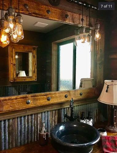 a bathroom with a sink and a mirror at Rainbows End Fishing Resort in Pinetop-Lakeside