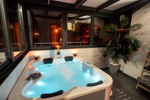 a large bath tub in a room with windows at IN LUX SPA APARTMAN in Vrnjačka Banja