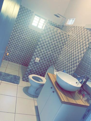 a bathroom with a toilet and a sink at Le Donjon du lycée in Sada