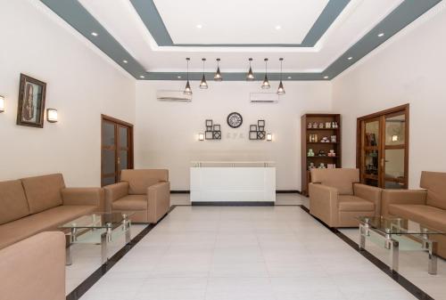 a hospital waiting room with couches and a table at Kiwengwa Beach Resort in Kiwengwa
