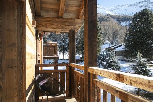 a view from the porch of a log cabin in the snow at Polaris 1 006 - LUXE & SKI LIFT apartment 6 pers in Zinal