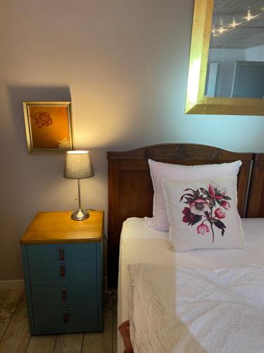 a bedroom with a bed and a table with a lamp at Apartmány Rudík in Železná Ruda