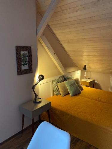a bedroom with a bed and a lamp on a table at Apartmány Rudík in Železná Ruda