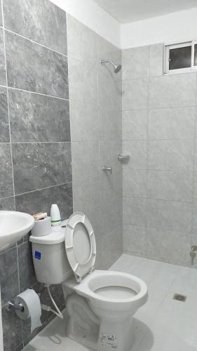 a bathroom with a toilet and a sink at Apartamento como en casa in Soledad