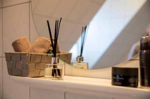 a bathroom shelf with a mirror and a sink at Hotel am Ludwigskanal in Wendelstein
