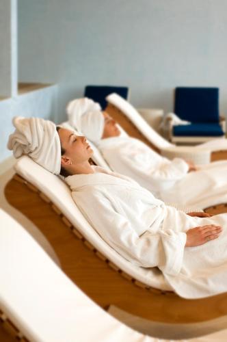 a woman laying in beds in a hospital at Relais La Colombara Spa & Wellness in Travo