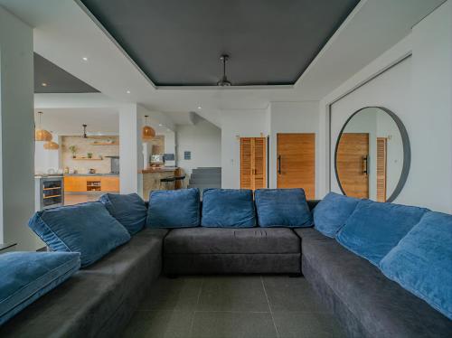 a large couch with blue pillows in a living room at Villa Mimpi Bali in Jimbaran
