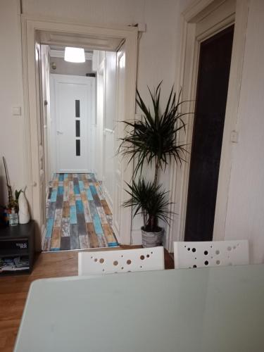 a room with two chairs and a hallway with a door at Pounette, appartement T3 centre / thermes Luxeuil in Luxeuil-les-Bains