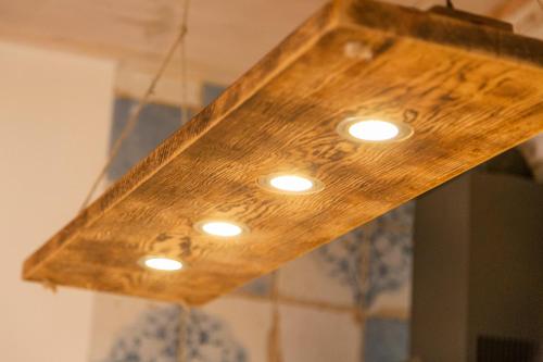 a wooden light hanging from a ceiling with lights at La Galiana loft nature in Casarejos
