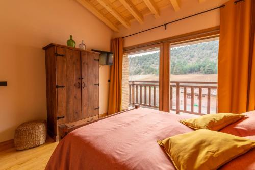 a bedroom with a bed and a large window at La Galiana loft nature in Casarejos