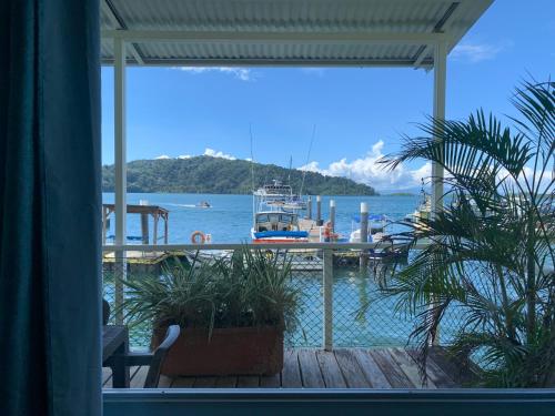 a view of a dock with a boat in the water at Banana Bay Marina in Golfito