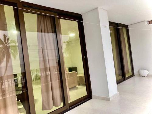 a building with glass windows and a living room at Apartamento Karey 203 Rodadero, Santa Marta in Santa Marta