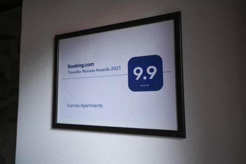 a framed picture of a clock on a wall at Sunrise Apartments in Niš