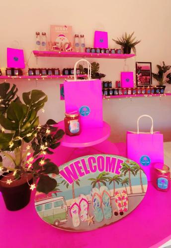 a pink table with a welcome sign and pink bags at Hotel & Apartments "CHEZ HIVA" in Hanga Roa
