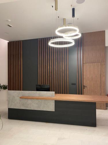 a lobby with a reception desk and a light fixture at Apartmani G8 in Pale